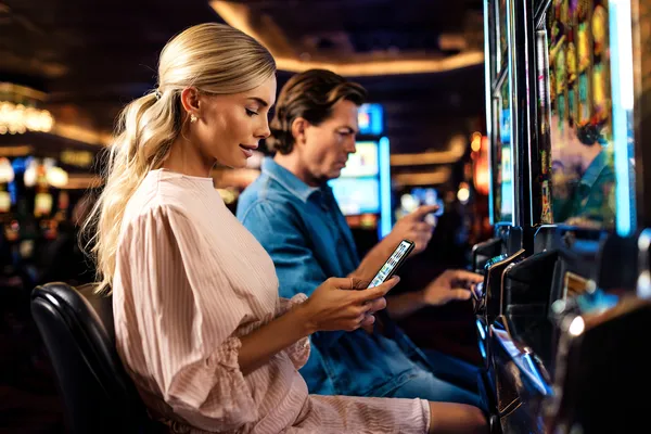 A cheerful woman in traditional clothing using her smartphone during a festive moment, showing how easily the MARAKUMI app fits into everyday life.